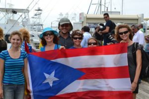 Our whole family behind the huge Puerto Rico flag that was used to welcome a Spanish Nobleman after he travelled very far and wide on a Jetski. He is travelling around the World duplicating old trade routes and raising money (I think).